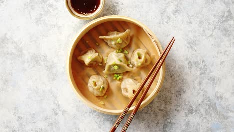 traditional chinese dumplings served in the wooden bamboo steamer