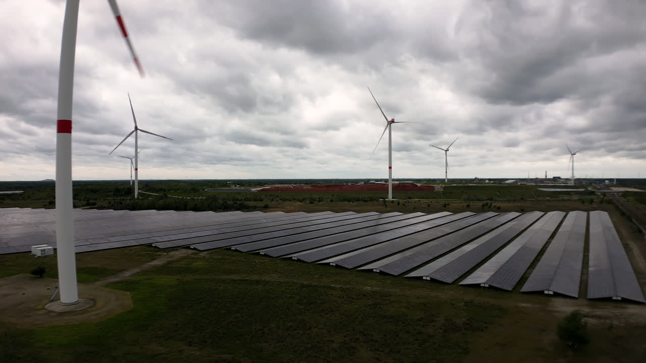 Field of green energy with wind and solar plants, aerial view