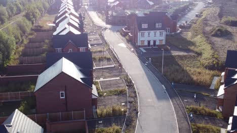 aerial reversing view morning sunrise over british suburban housing development building site