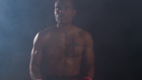 man shadowboxing in red boxing gloves