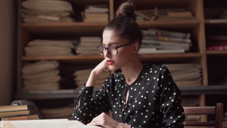 woman gets an idea for something to write in a library