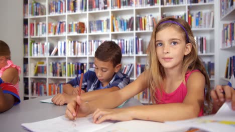School-kids-drawing-in-book-in-classroom