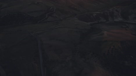 drone flying over italian landscape with the camera tilting upwards slowly from down position at sunrise in 4k