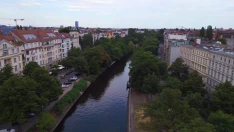 Nice-aerial-top-view-flight-City-Berlin-district-Neukoeln-canal-bridge-river,-Germany-Summer-day-2023