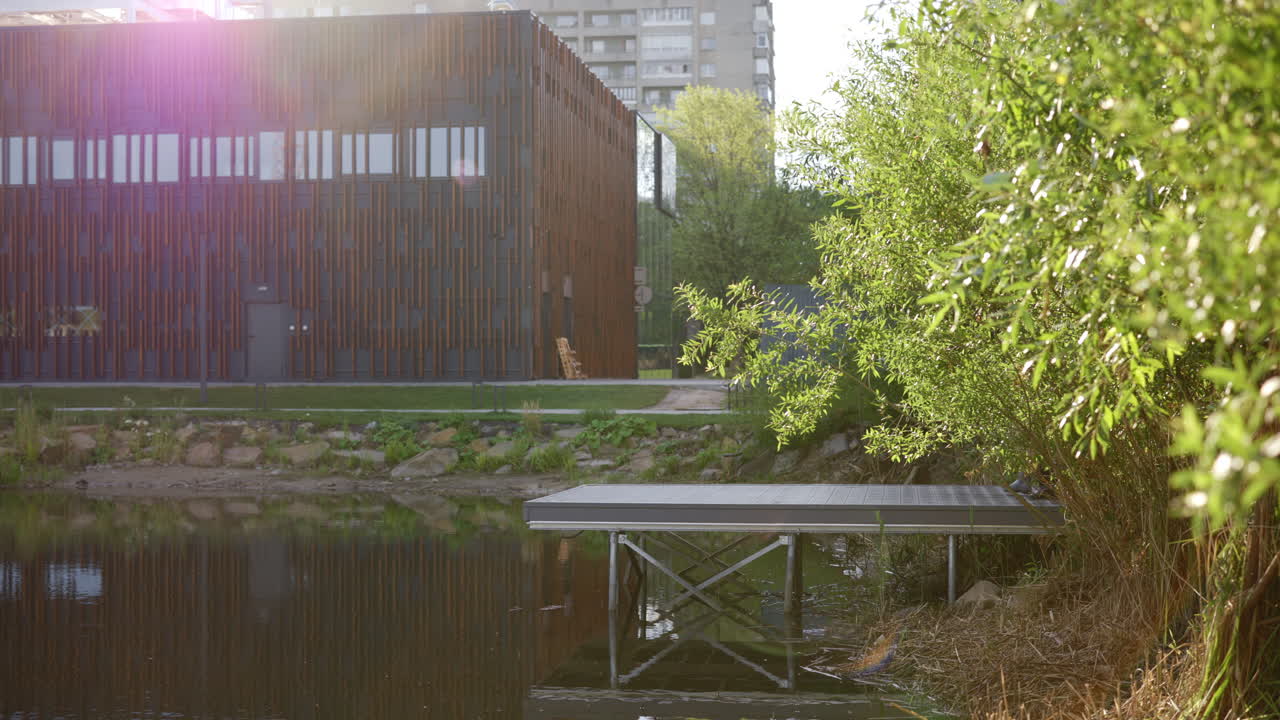 Fishing Pier with Modern Building and Pond