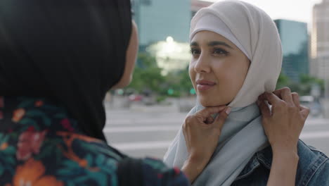 portrait of muslim woman mother enjoying caring for young student daughter preparation for college proud of tradition in urban city background