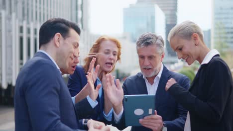 diverse business professionals engaged in video call on tablet outdoors
