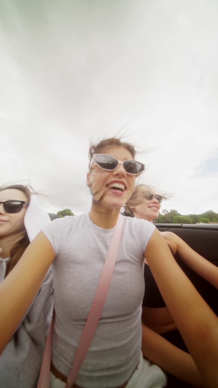 Women enjoying a road trip in a convertible