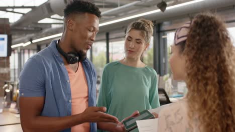 happy diverse casual business colleagues with tablet and paperwork talking in office, slow motion