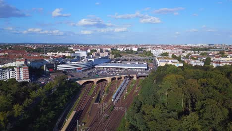 Gorgeous-aerial-top-view-flight-tracks-yellow-suburban-train-Platform-S-Bahn-Station-bridge,-Berlin-mitte-summer-2023