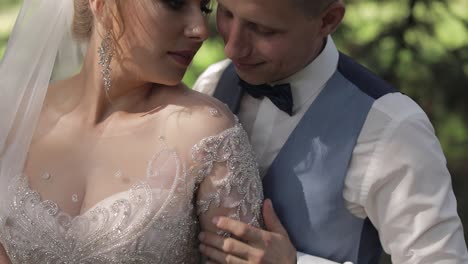 newlyweds. caucasian groom with bride in the park. wedding couple. happy family
