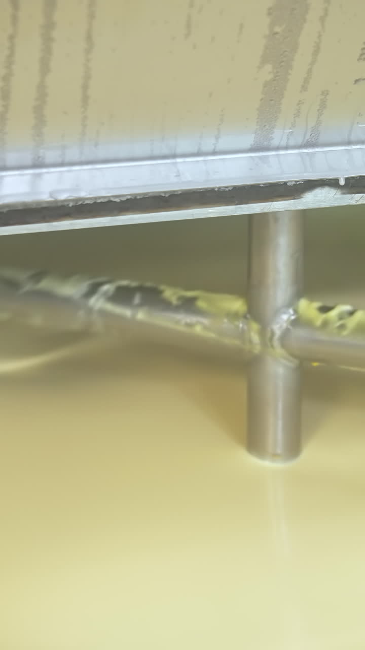 Butter production line at dairy industry. Close up view of butter production at dairy plant Vertical video