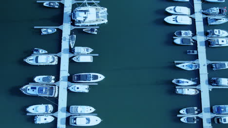 Aerial-view-of-boats-docked-in-a-marina-with-calm-waters