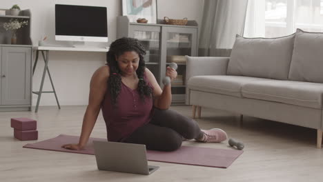 african woman having online training at home
