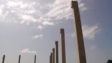 construction site, concrete columns against a blue sky.