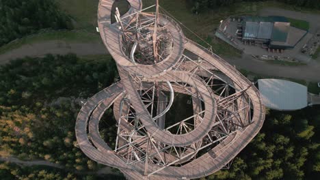 a breathtaking top-down view of the trail in the clouds in dolní morava with an elevated wooden walkway creating astonishing spirals