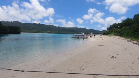 tourist boats moored at kabira bay, ishigaki island, okinawa, japan. wide angle pan left shot