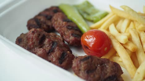 grilled kofta with french fries and vegetables