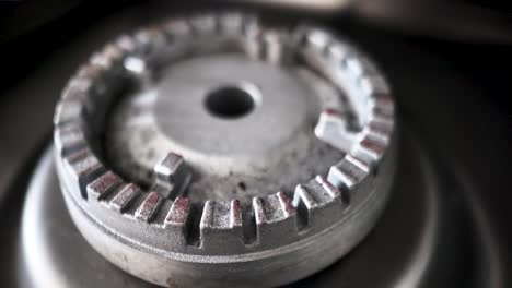 gas cooker burner head showing rust and dirt, indicating frequent use and the need for cleaning or replacement