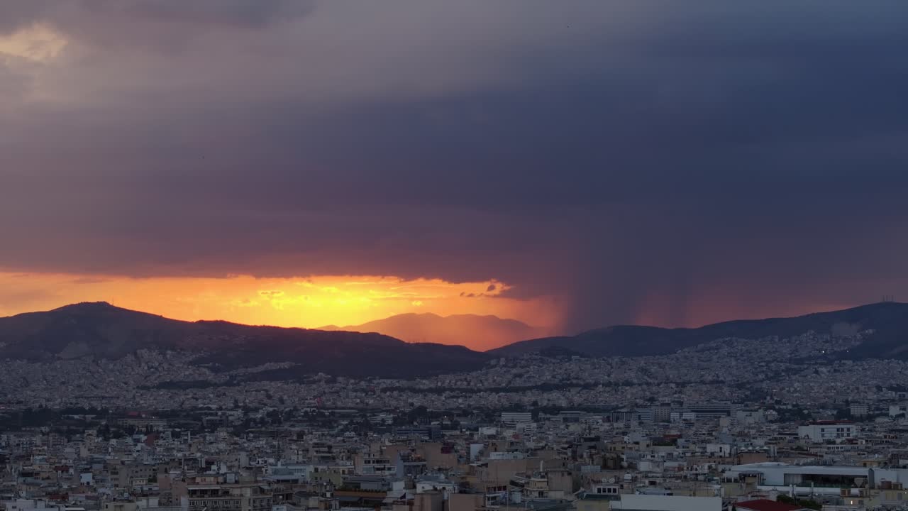 Drone shot of Athens with cloudy sunset in the background