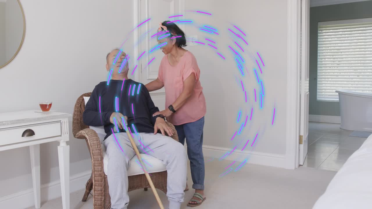 Senior woman taking man's arm, guiding him to chair with cane, blue-violet ring highlighting health