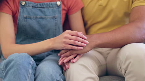 hands, love and empathy with a couple on a sofa