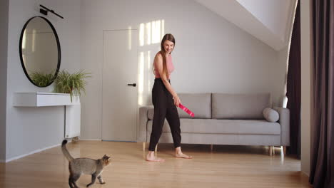 woman feeding her cat in a cozy living room