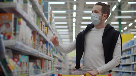 man shopping in supermarket with mask