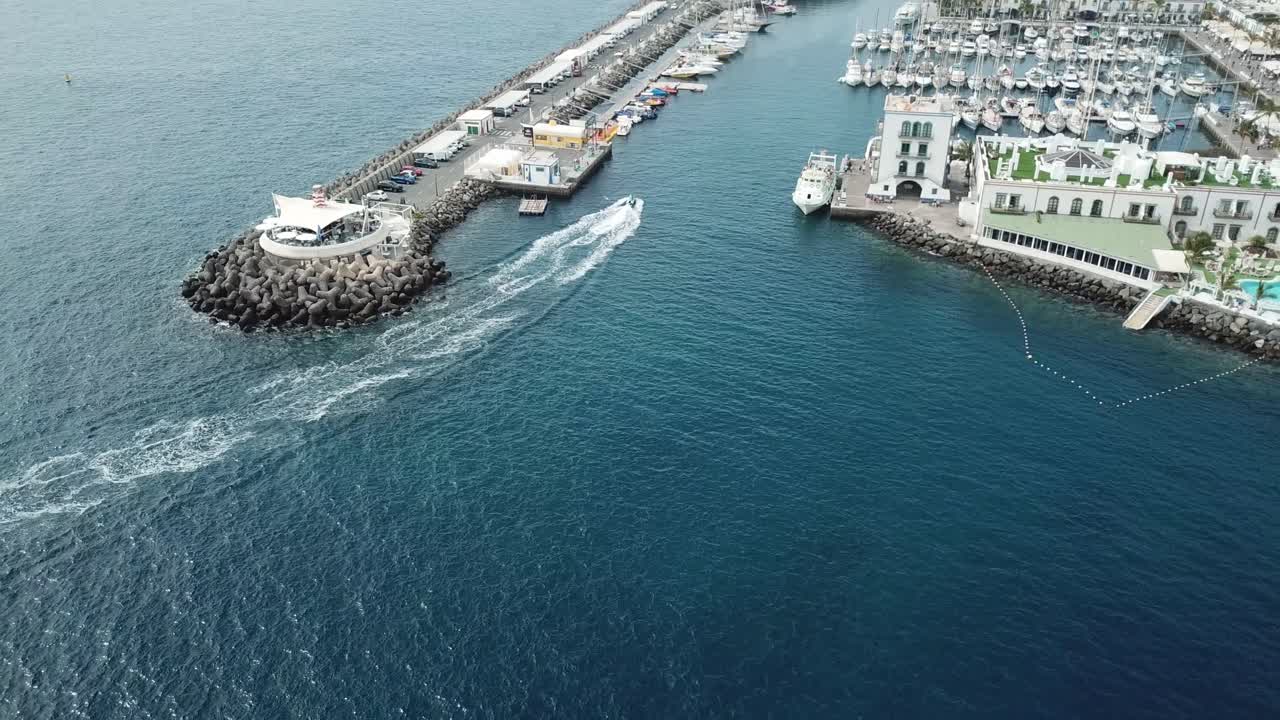 From above, Puerto de Mogán’s marina and its winding streets come to life. The vibrant town hugs the coast, with yachts docked in the harbor and the waves of the Atlantic gently washing ashore.