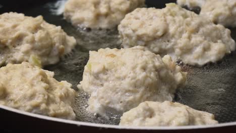 chicken meatballs frying in pan