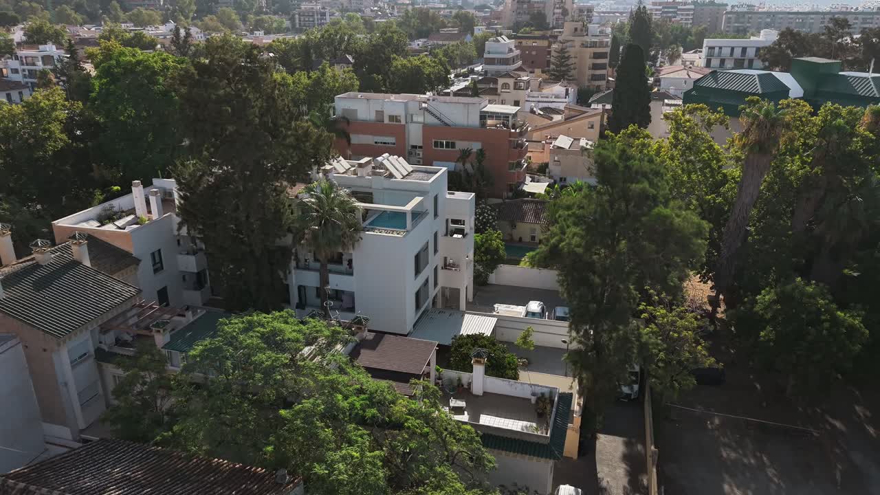 Zoomed view of a quiet neighborhood featuring a terrace pool atop a house