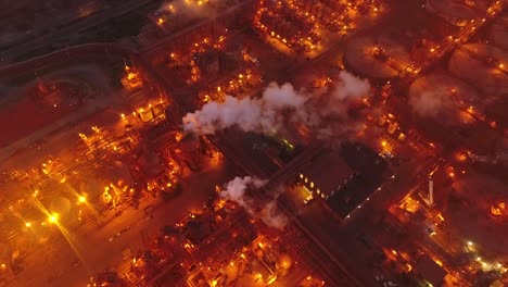 Drone-top-down-of-metal-factory-at-night