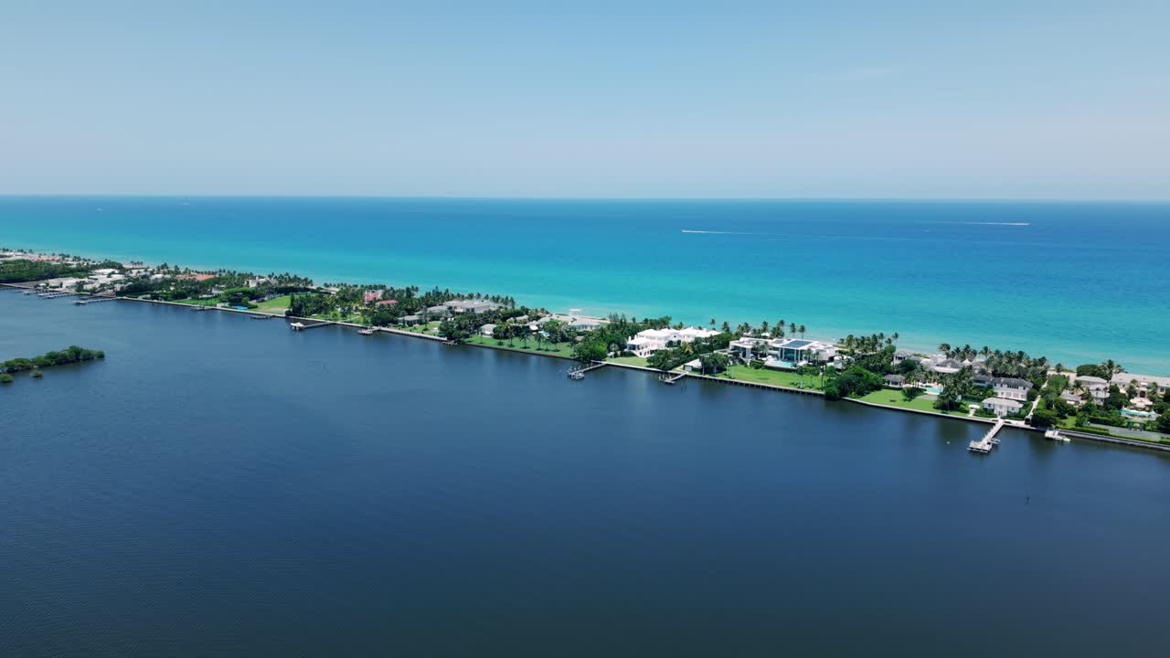 Aerial flyover showing clear water near coastline by Flagler Beach, West Palm Beach