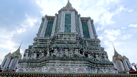 majestic view of wat arun temple under cloudy sky in bangkok