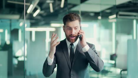 angry evil male businessman cry talking on the mobile phone in office. business man shouting on call indoor