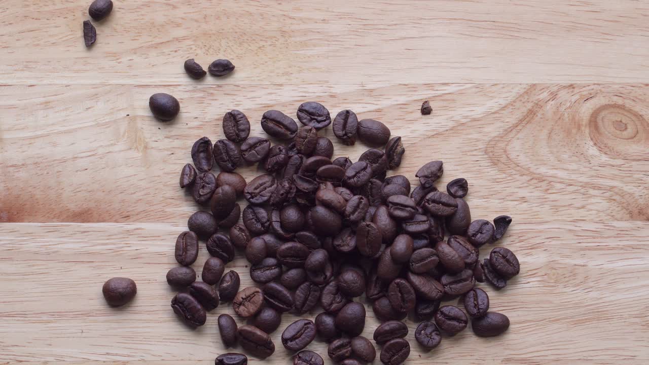 4k imágenes. 4096x2304p. granos de café perfumados son asados en una sartén, el humo proviene de los granos de café. toda la composición se desplaza lentamente alrededor de la cámara. cucharada agitar granos de cafe.