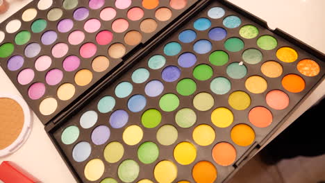 colorful makeup palette with yellow, orange, purple, blue, pink and green