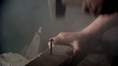 hammer hitting a big nail in a dramatic misty ambience