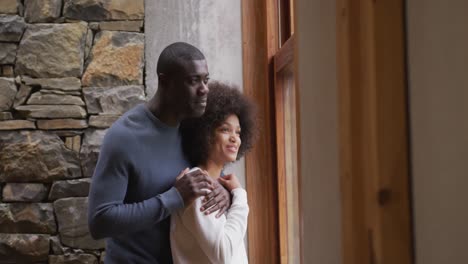 couple looking through the windows at home