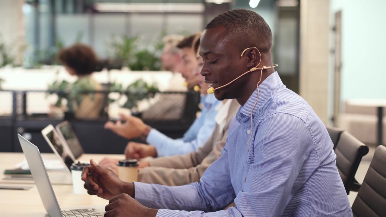 African American Man Talking on Headset in Modern Office