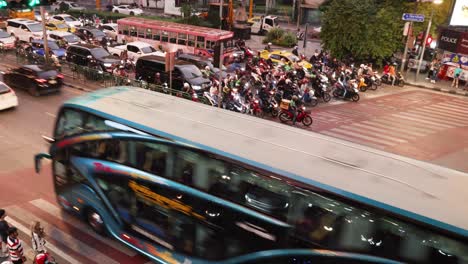 pedestrians and vehicles crossing a bustling intersection