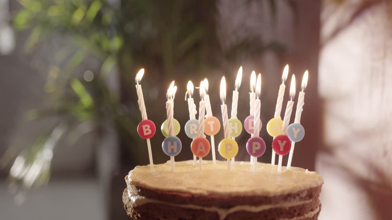 Premium stock video - Lighting the candles on a birthday cake with a ...