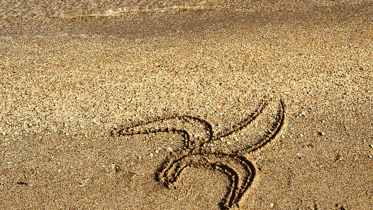 Banana drawing on sand, the beach. Drawing on sand