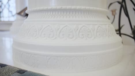 ornate carved white marble column base