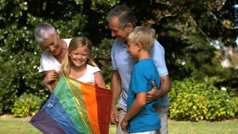 Little-girl-holding-a-kite-with-her-grandparents-