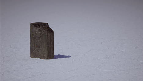 old canister resting on vast salt flat under bright sunlight