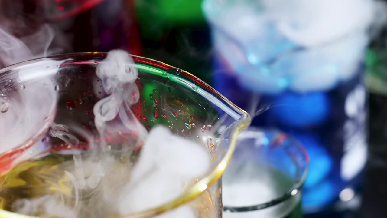Close-up view of colorful beakers emitting vibrant smoke, showcasing a mesmerizing chemical reaction.
