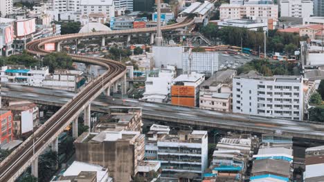 time-lapse of car traffic transportation at the victory monument roundabout in bangkok, thailand. asian city life, asia travel landmark, public transport, or commuter lifestyle concept. tilt up