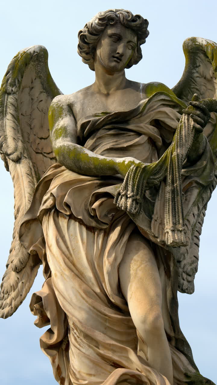 Marble statue of angel on Saint Angel Bridge in Rome, Italy. Vertical