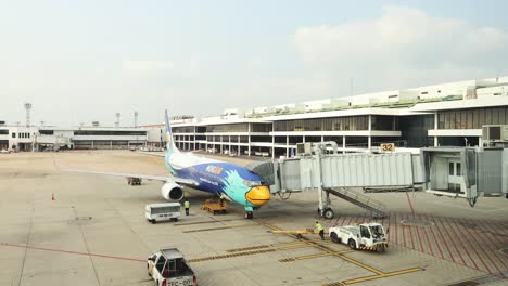 passengers boarding an airplane at the gate